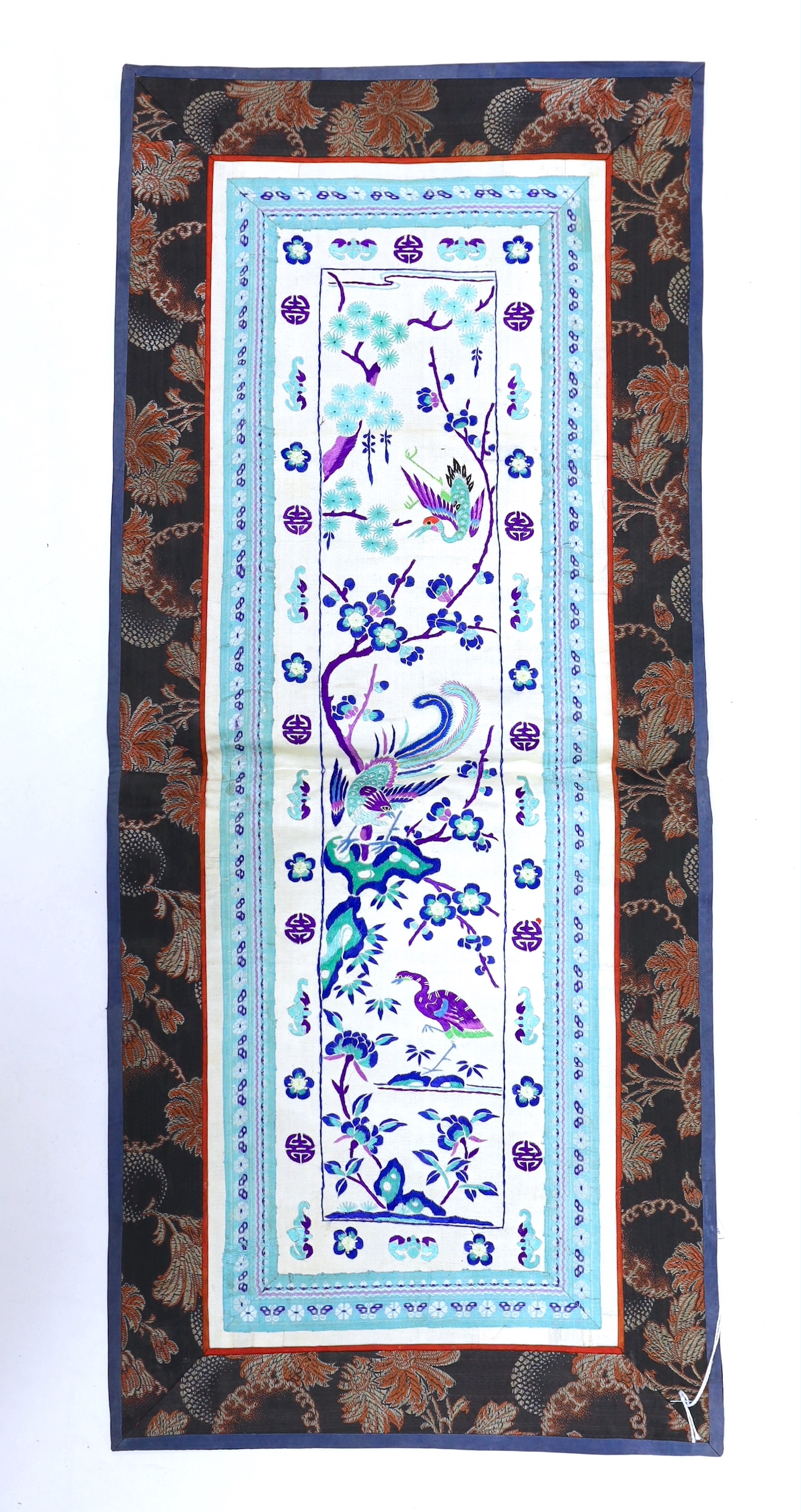 Three pairs of Chinese embroidered sleeve bands, polychrome silk designs on cream silk background, together with a single sleeve band, all bordered with damask silk, longest panel including border 66cm x 35cm wide